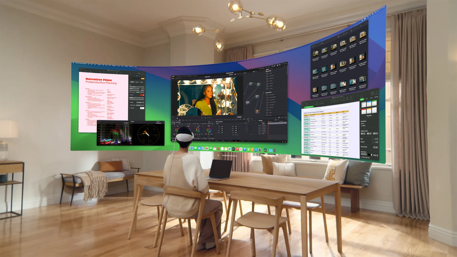 A person using Apple Vision Pro with an ultrawide Mac Virtual Display and several work applications open